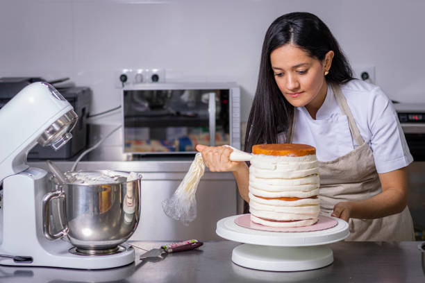 istock Colombian Pastry Chef Using A Pastry Bag 1473547649
