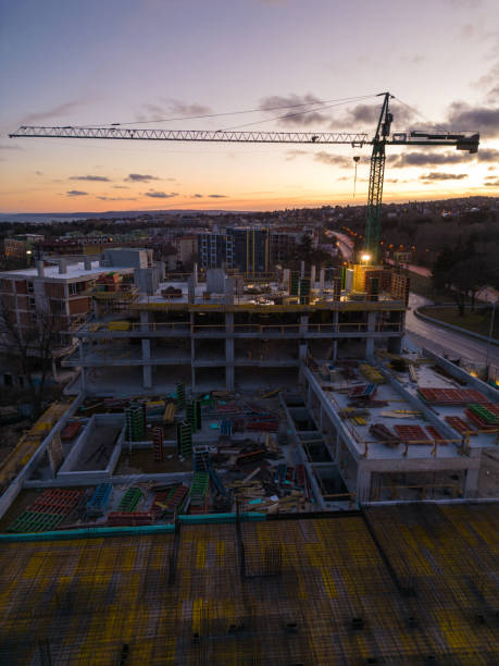 istock Busy Construction Site and Construction Equipment at night. Aerial view 1473551514