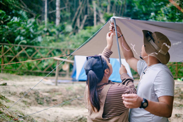 istock Asian couples setting up a tent together. 1473553105