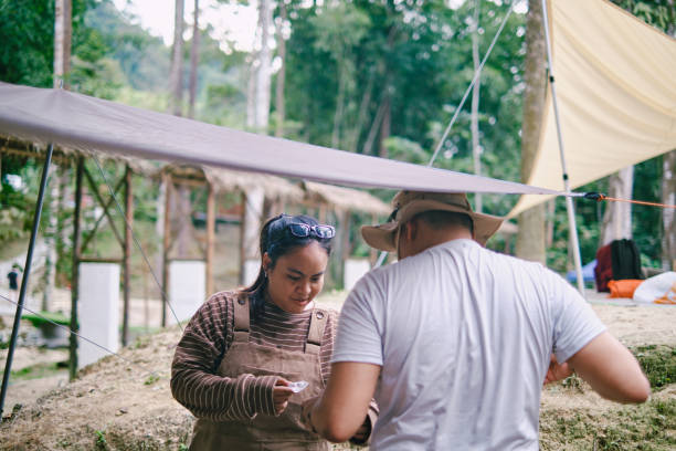 istock Asian couples setting up a tent together. 1473553106