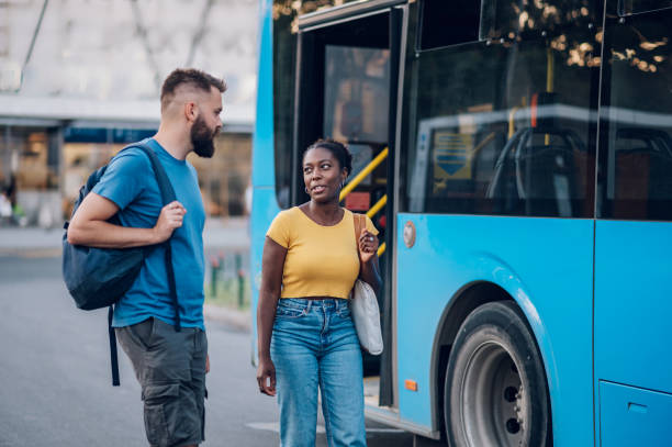 istock Multiracial friends waiting public transportation on a bus stop 1473559195