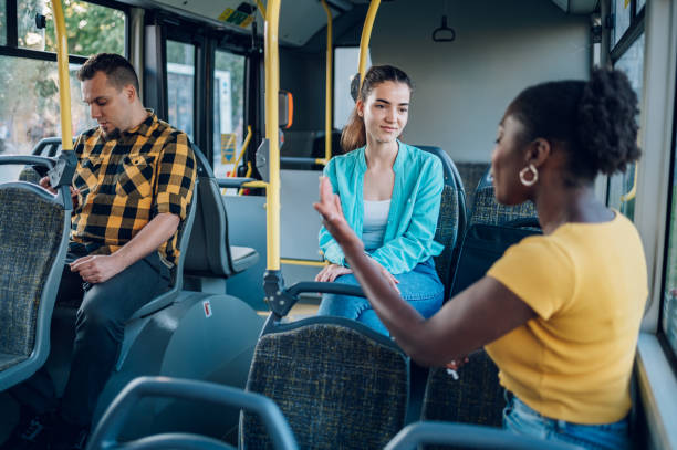 istock Multiracial friends talking while riding a bus in the city 1473559204