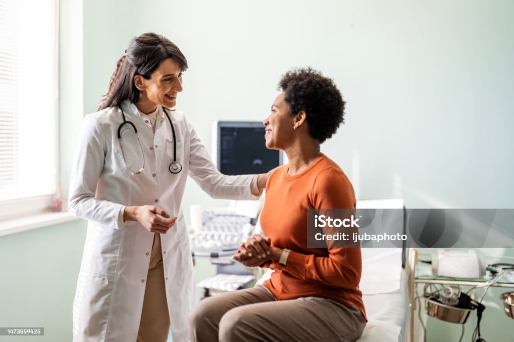Female medical practitioner reassuring a patient Doctor Stock Photo