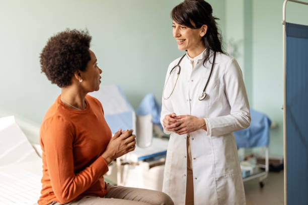 istock Female patient is explaining her problems as the doctor listens intently. 1473559436