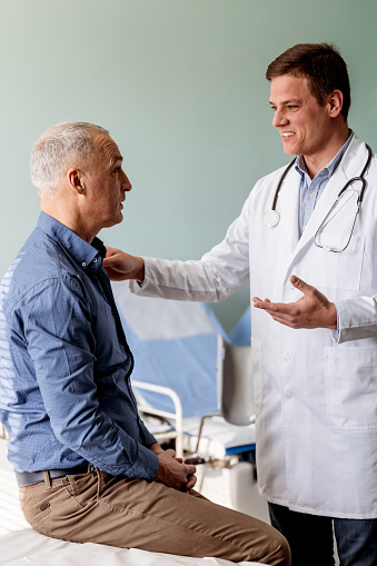 Doctor consoling mature man