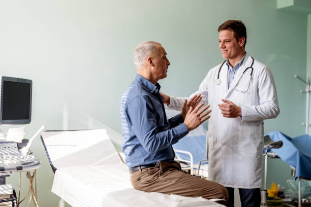 Caring doctor listens to patient stock photo