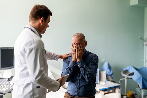 Doctor In Consultation With Depressed Male Patient