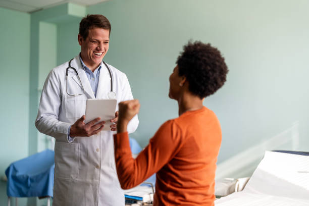 istock Female patient is relieved as doctor explains test results 1473559628
