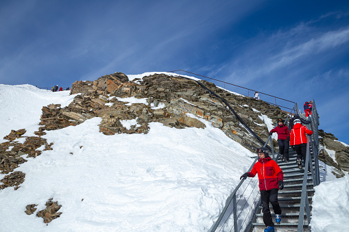 Neustift im Stubaital, Austria – February 16, 2023: Tourists wearing ski clothing at platform on the top of the Alps mountain range