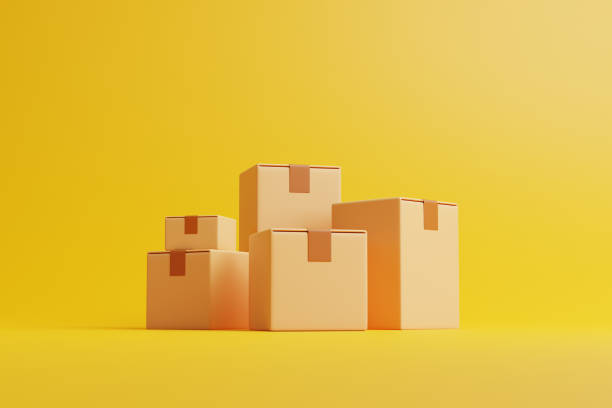 istock A group of brown cardboard boxes on a yellow background. Side view 1473560655