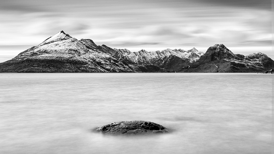 A peaceful, monotone long exposure image taken of the Cuillin mountains from Ergol on the Isle of Sky, Scotland.