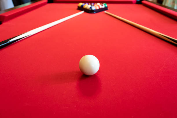istock Red billiard table with billiard balls and cues 1473565539