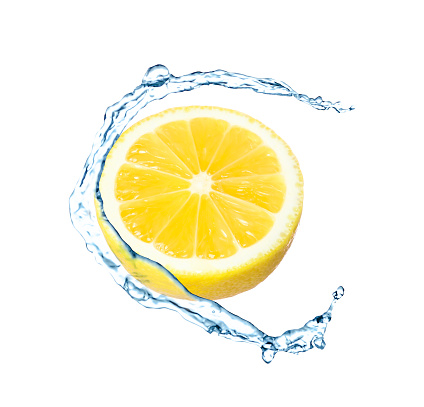 Fresh ripe lemon and splashing water on white background