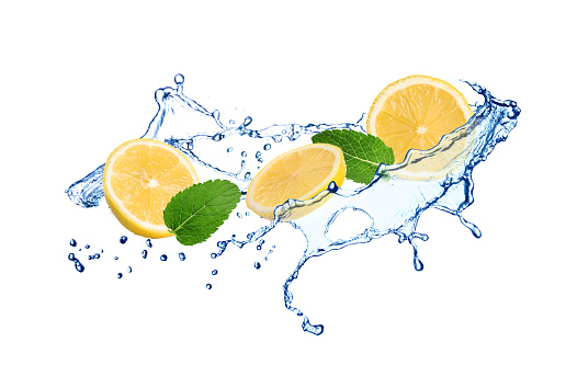 Fresh ripe lemon, mint and splashing water on white background