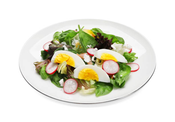 istock Delicious salad with boiled egg, radish and cheese isolated on white 1473566812