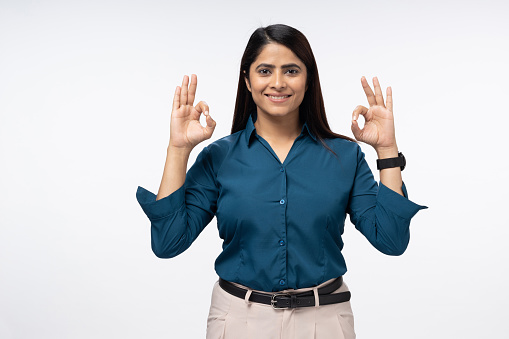 beautiful cheerful smiling young woman wearing formal shirt is ok sign