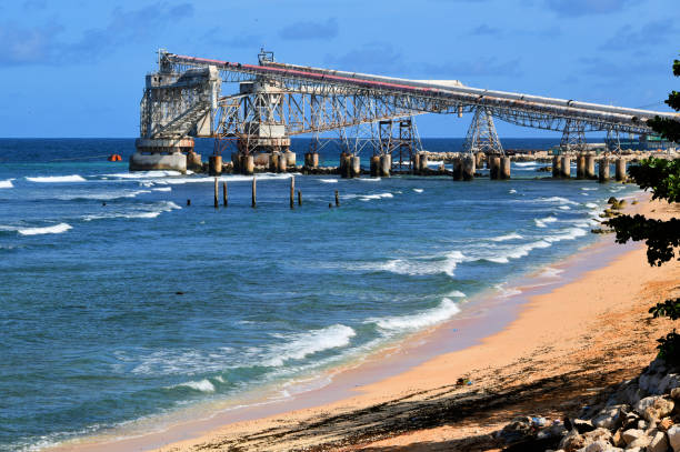 Aiwo, Nauru island: Cantilever 2 -  Nauru Phosphate Cantilevers, massive steel cantilevers erected to load phosphate directly on large ships moored just off the reef - Although the initial layer of phosphate has been mined out (approximately 100 million tonnes), the island is believed to have a secondary level of phosphate, holding nearly 20 million tonnes of minable resources. Republic of Nauru Phosphate Corporation (RONPhos / NPC).