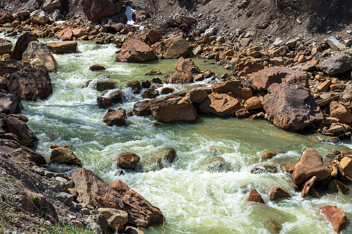 Fast-flowing spring runoff past the rocky banks of Canyon Creek near the town of Ouray in western \ncolorado