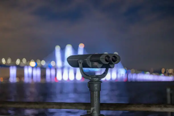 Photo of Binoculars at Tarrytown Overlook with the Governor Mario M. Cuomo Bridge and Hudson River in the background.