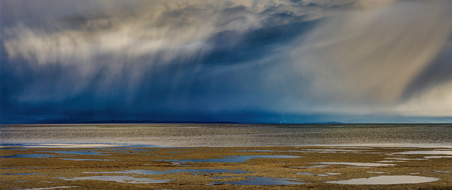 stormy raining clouds over sea and beach