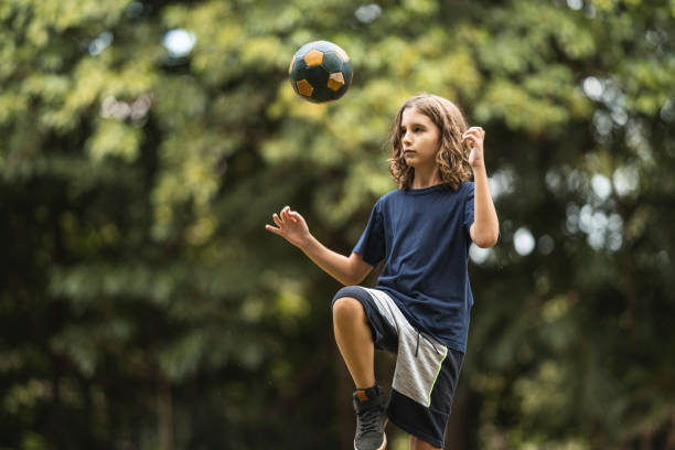 istock Boy training soccer ball skills 1473575961