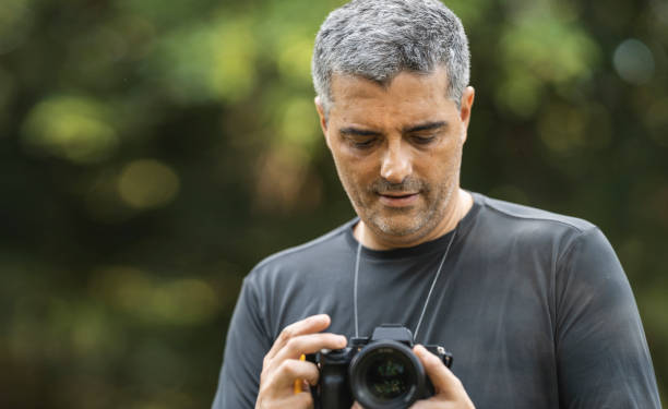 istock Videographer filming with camera in hand 1473576198