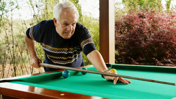 istock Retired man playing billiards in patio 1473577588