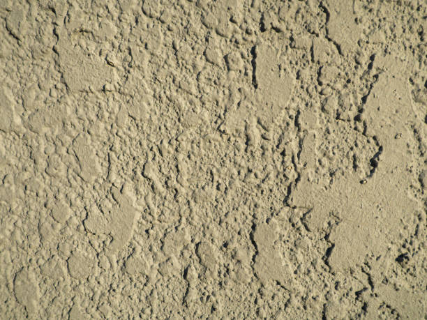 istock Rough light surface. Background from a stone wall. Cement stains.  White background 1473578481