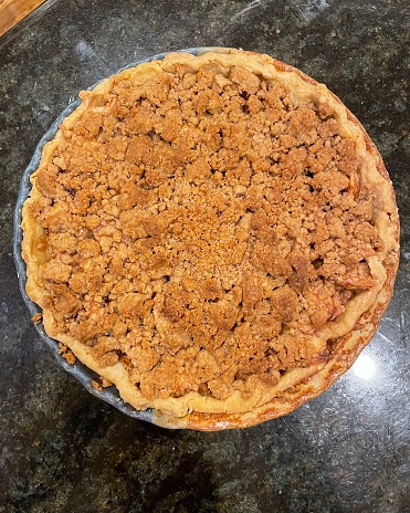 Apple crumble pie in a ceramic pie plate