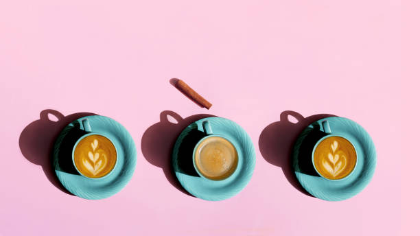 istock Cups with coffee and cappuccino on a pink background 1473581694