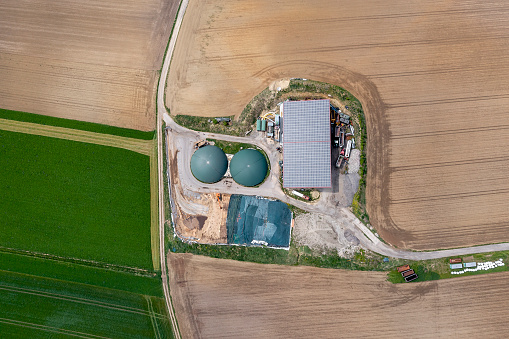 Renewable energy sources on a farm, biogas and solar power plant viewed from directly above.