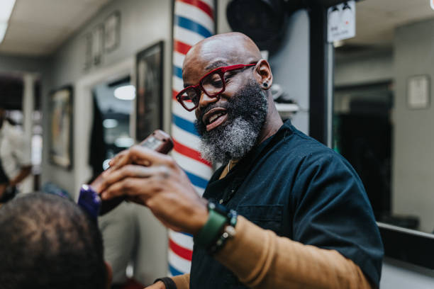 istock Middle aged black man working in barber shop 1473584858