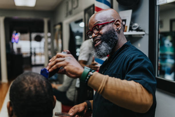 istock Middle aged black man working in barber shop 1473584862