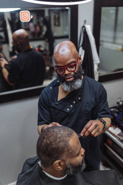 istock Black man working in barber shop 1473584870