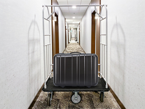 Trolley with luggage bag in front of a corridor