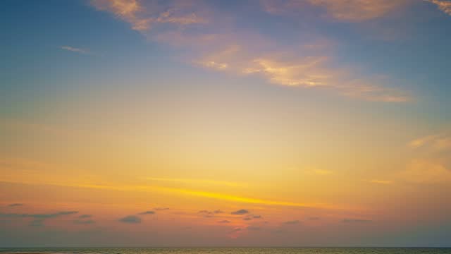 Time lapse of Majestic sunset or sunrise over sea landscape,Amazing light of nature cloudscape sky and Clouds moving away rolling, Colorful sunset light dramatic clouds in golden hour Footage