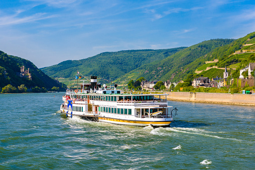 Touristic cruise passenger motor ship boat and vineyards in Ruedesheim am Rhein Rhine, Rudesheim, Rheingau-Taunus-Kreis, Darmstadt, Hessen, Germany.