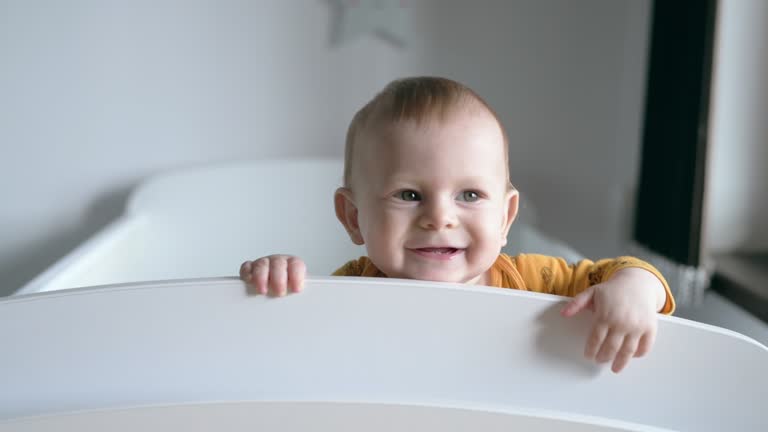 Happy baby in his crib.