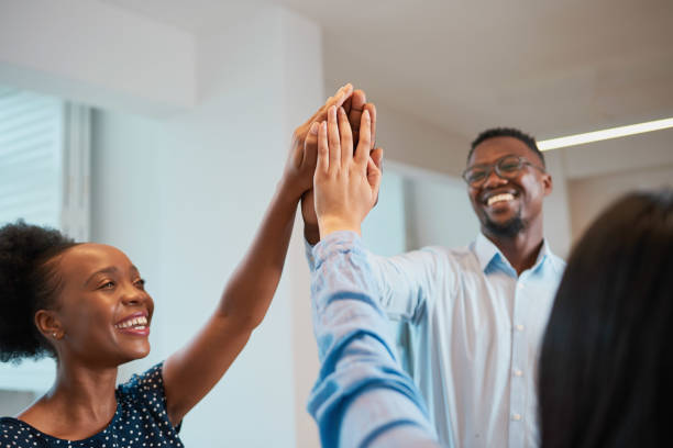 istock Three colleagues give high five in office, celebrate success, happy teamwork 1473593806
