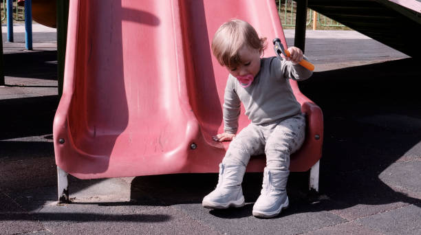istock Baby playing on a playground in spring. 1473593923