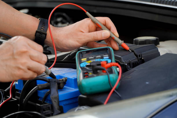 istock technician checks the battery using a voltmeter capacity tester,auto mechanic uses a multimeter voltmeter to check the voltage level in a car battery 1473597181
