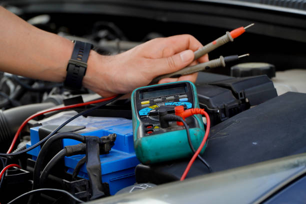 istock technician checks the battery using a voltmeter capacity tester,auto mechanic uses a multimeter voltmeter to check the voltage level in a car battery 1473597182