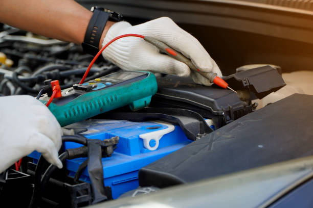 istock technician checks the battery using a voltmeter capacity tester,For maintenance work in industrial plants to engine repair work in garages,bettry dead, time to replace 1473597184