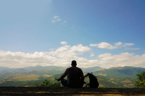 Silhouette of male tourists Sit with backpack. in Dilijan, Tavush Province, Armenia