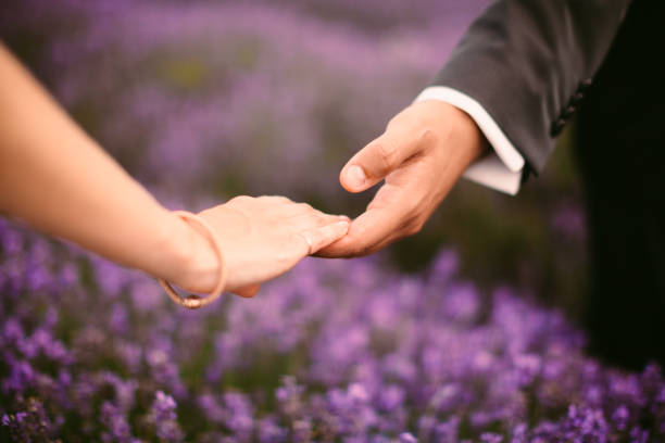couple holding hands in lavender field in Saint-Rémy-de-Provence, Provence-Alpes-Côte d'Azur, France