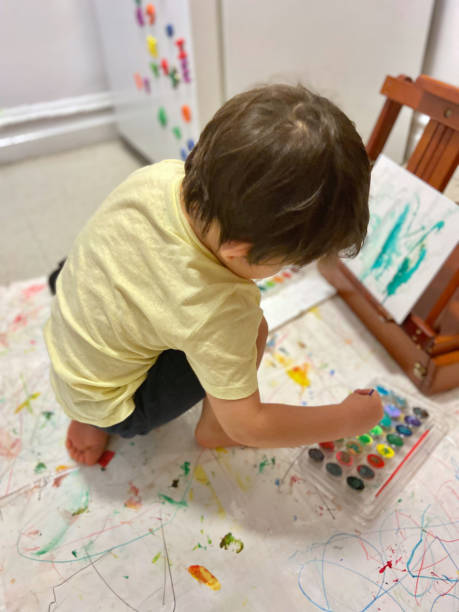 istock Toddler sitting painting canvas 1473603805