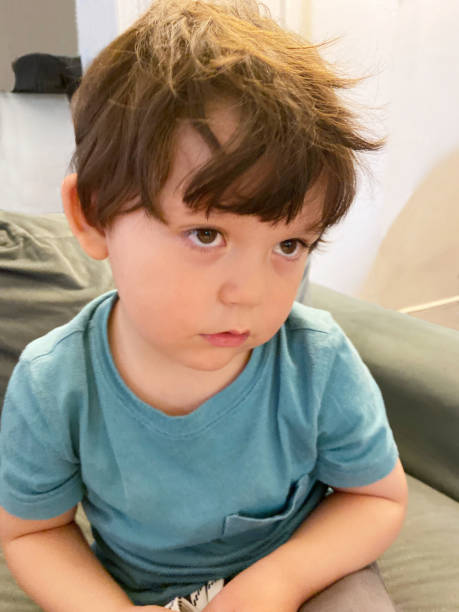 istock Toddler sitting in a sofa at home 1473603899