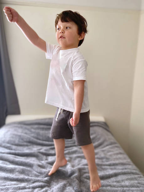 istock Toddler jumping in bed 1473603923