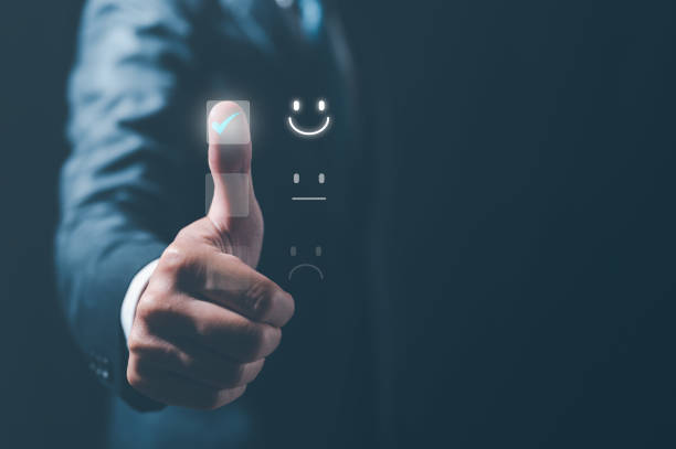 istock Customer service satisfaction survey concept.Business people or customers show satisfaction by pressing face emoticon smile in satisfaction on virtual touch screen. 1473603952