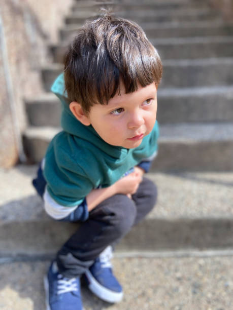 istock Toddler sitting at stairs 1473604844